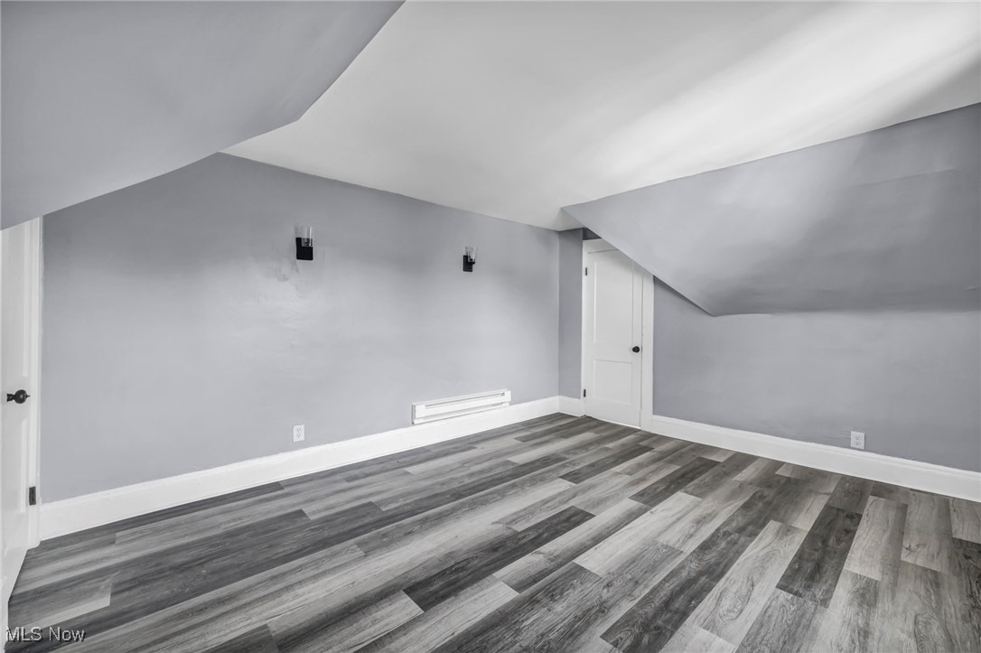 10112 Kinsman Road Cleveland, OH 44104 - Photo 41 of 49 Additional living space featuring lofted ceiling, wood finished floors, and baseboard heating