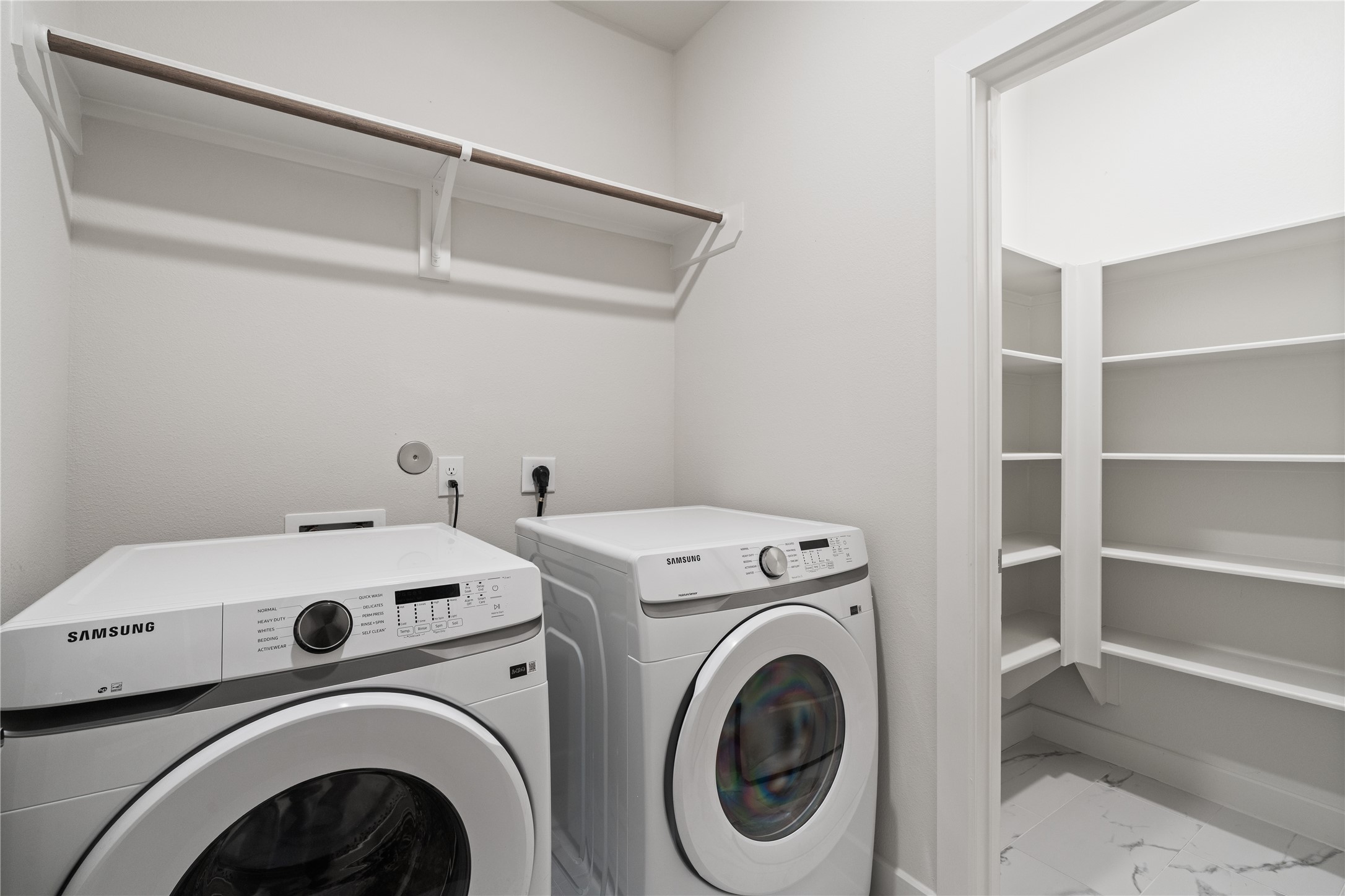 6451 Rena Street Houston, TX 77092 - Photo 31 of 33 Spacious laundry room with side by side setup, upper hanging space, and a dedicated storage closet with built in shelving for added organization.