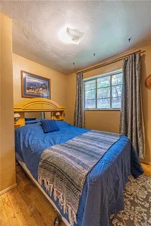 a bed sitting in a bedroom next to a window