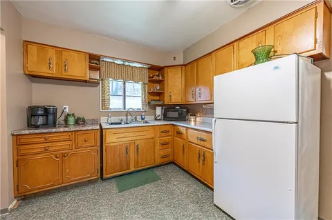 a kitchen with sink cabinets and refrigerator