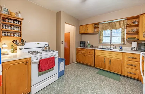 a kitchen with stainless steel appliances a stove a sink and a refrigerator