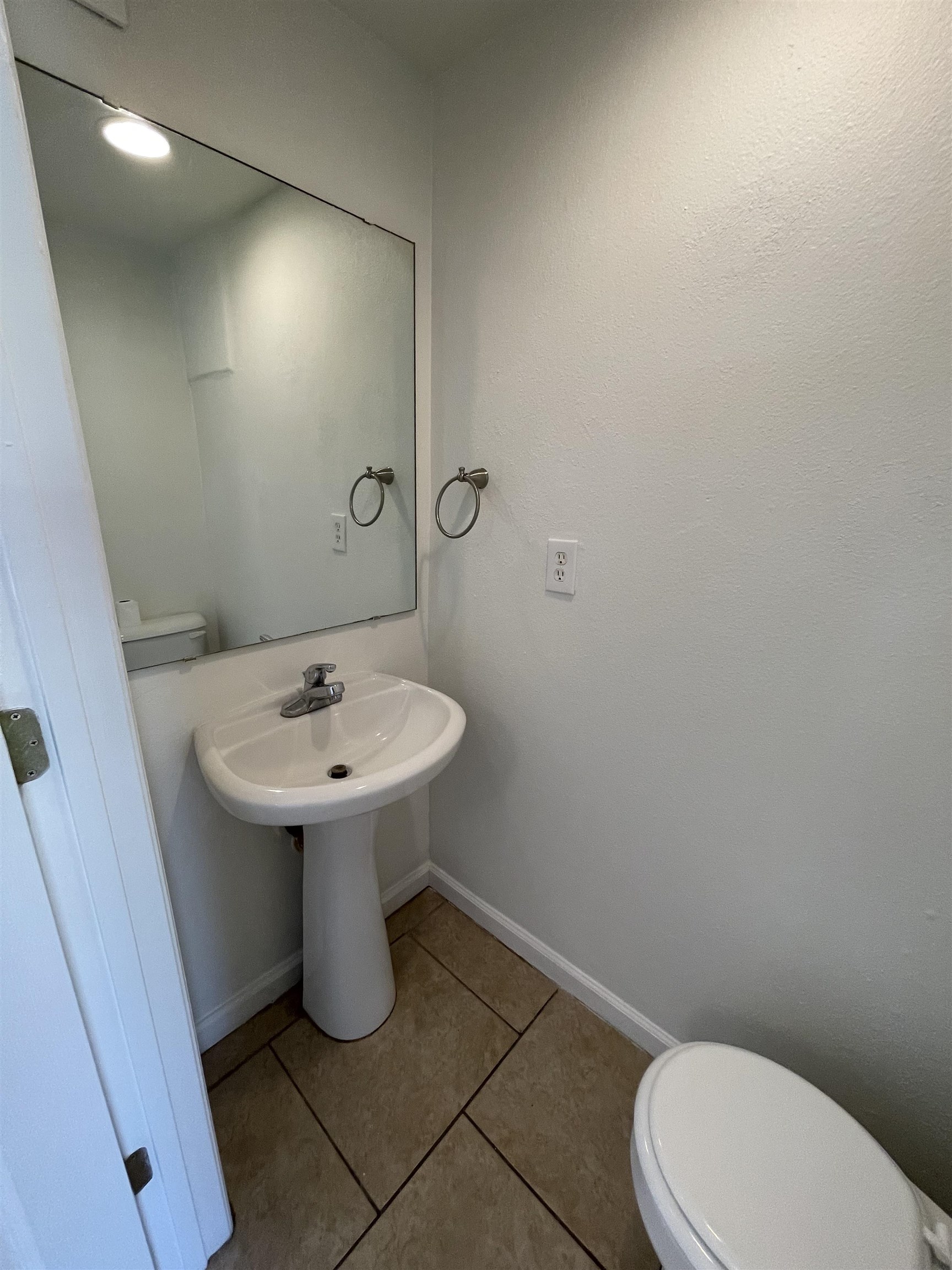 4420 Carter Road, Unit 18 St. Augustine, FL 32086 - Photo 7 of 17 a bathroom with a sink a toilet and mirror