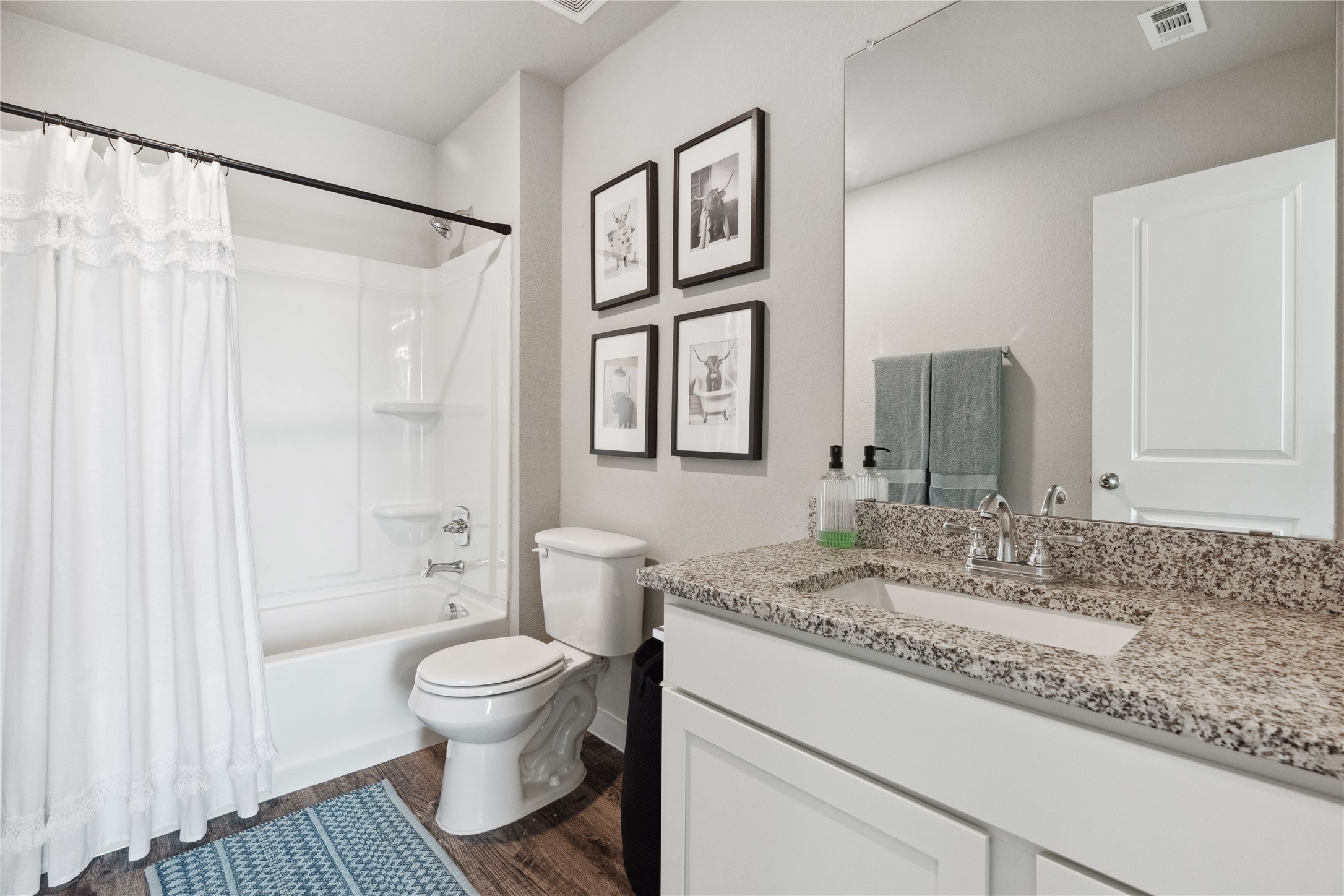 523 Powell Drive Leander, TX 78641 - Photo 19 of 25 a bathroom with a granite countertop sink toilet and shower