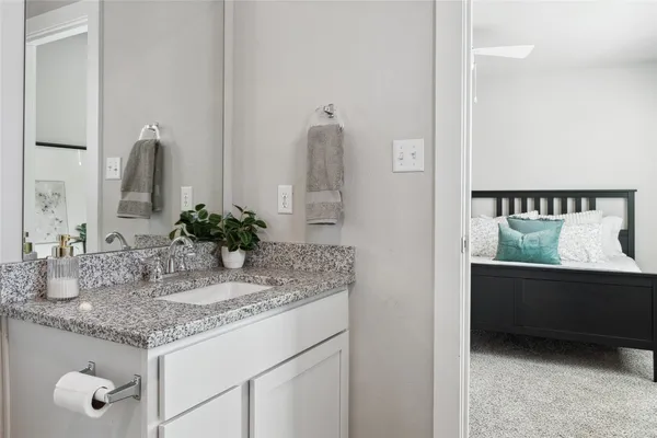 a bedroom with a bed and a dresser