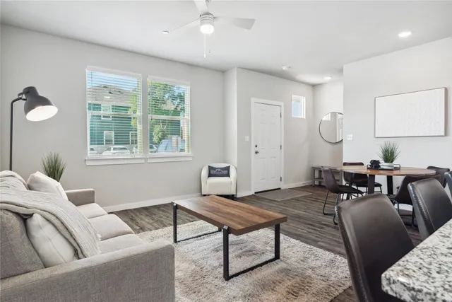a living room with furniture a rug and a window
