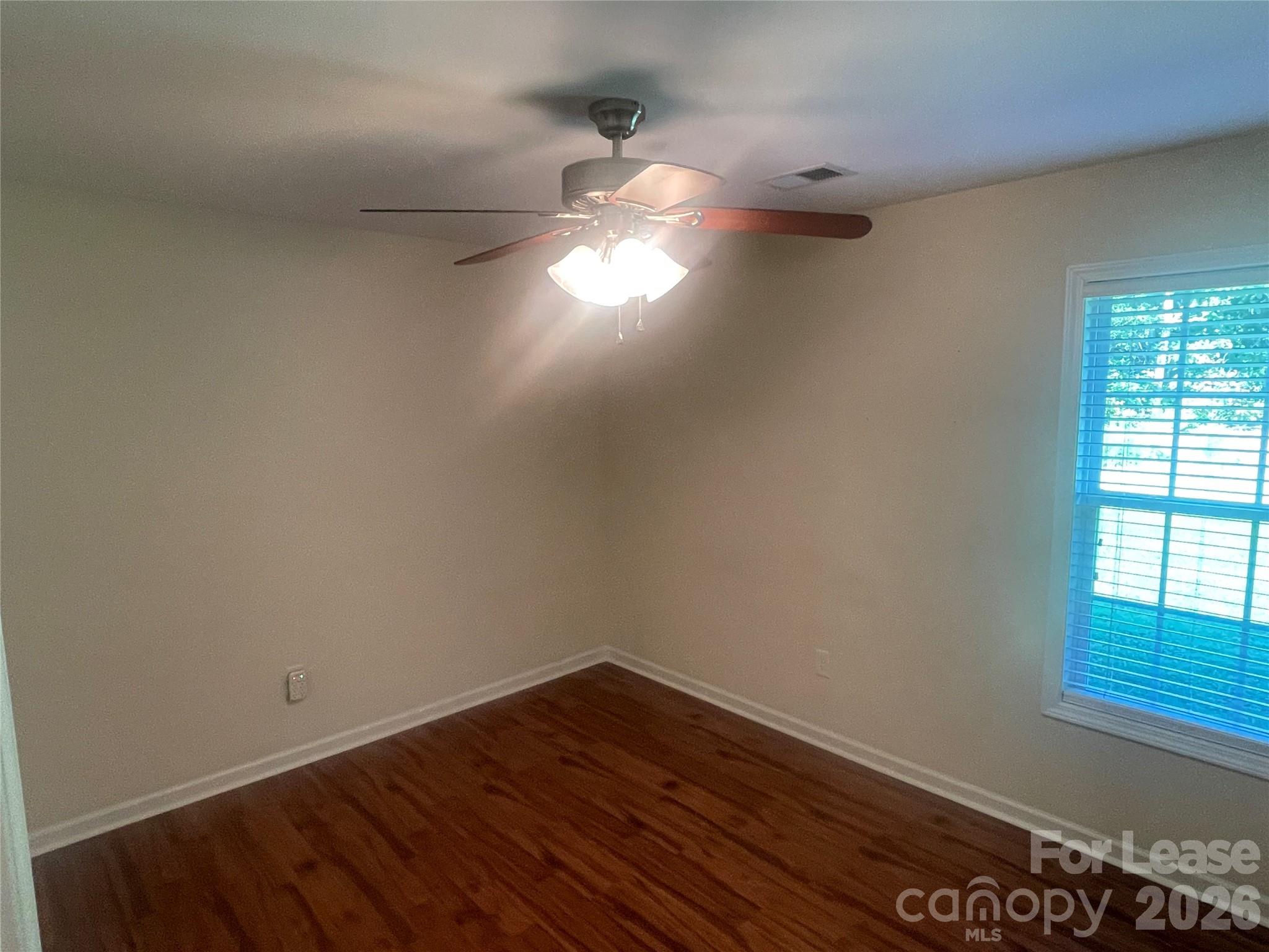 3791 Lee Moore Road Maiden, NC 28650 - Photo 10 of 11 a view of empty room with wooden floor and fan