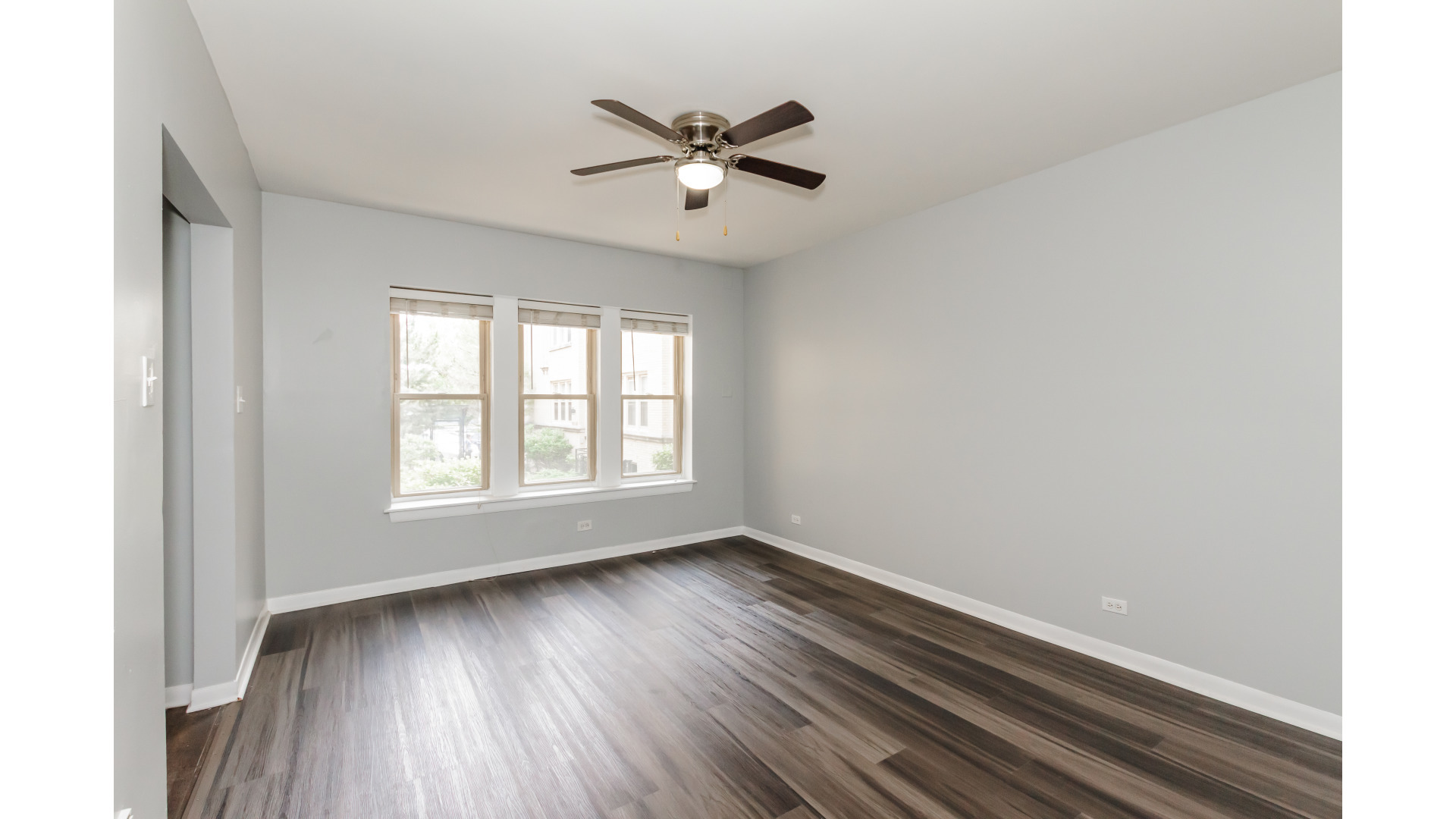 2400 North Kilbourn Avenue, Unit 2 Chicago, IL 60639 - Photo 3 of 10 a view of empty room with wooden floor and fan
