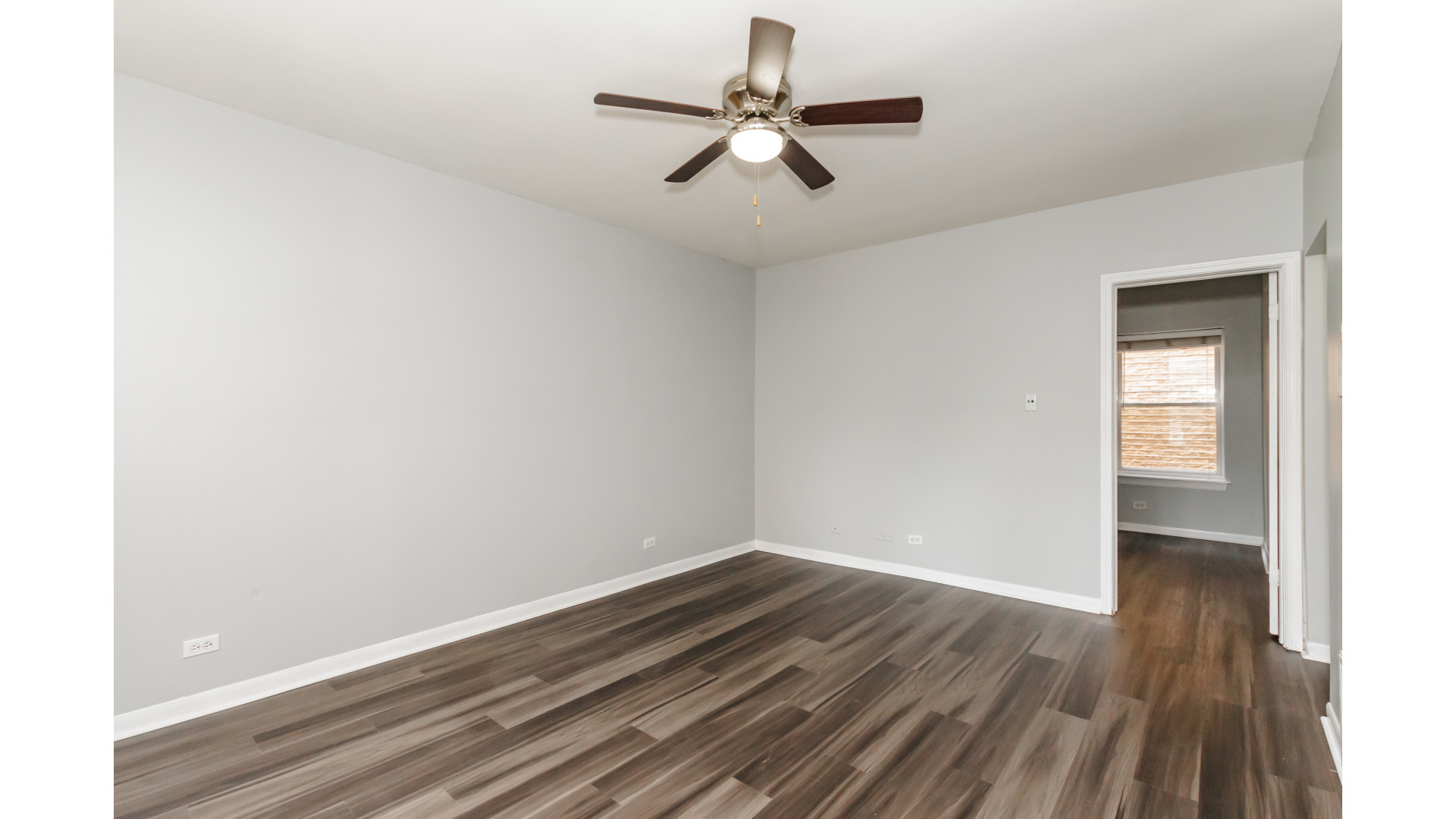 2400 North Kilbourn Avenue, Unit 2 Chicago, IL 60639 - Photo 4 of 10 a view of room with window ceiling fan and hardwood floor