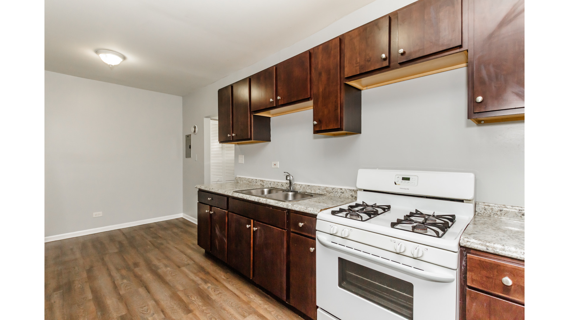 2400 North Kilbourn Avenue, Unit 2 Chicago, IL 60639 - Photo 6 of 10 a kitchen with stainless steel appliances a stove a sink and a microwave