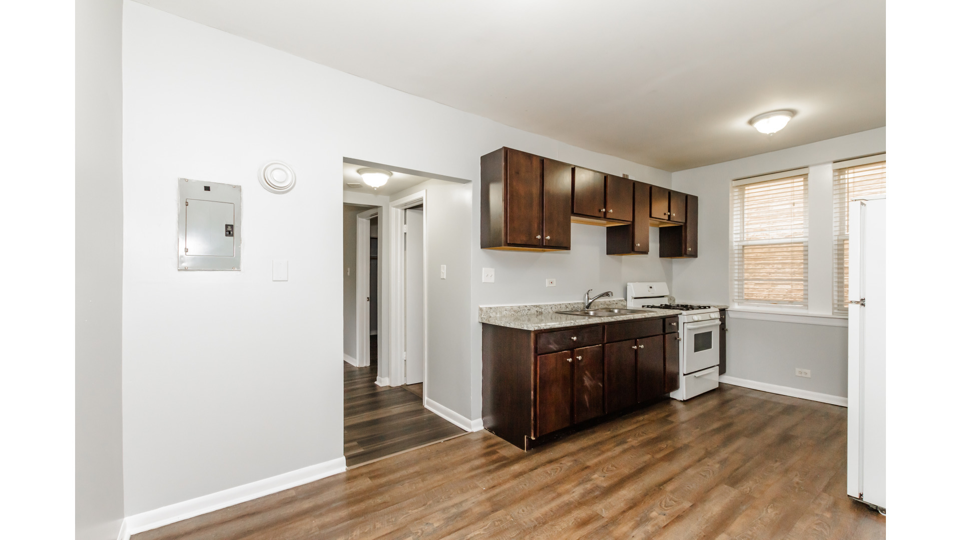 2400 North Kilbourn Avenue, Unit 2 Chicago, IL 60639 - Photo 7 of 10 a large kitchen with stainless steel appliances granite countertop a stove a sink and a refrigerator