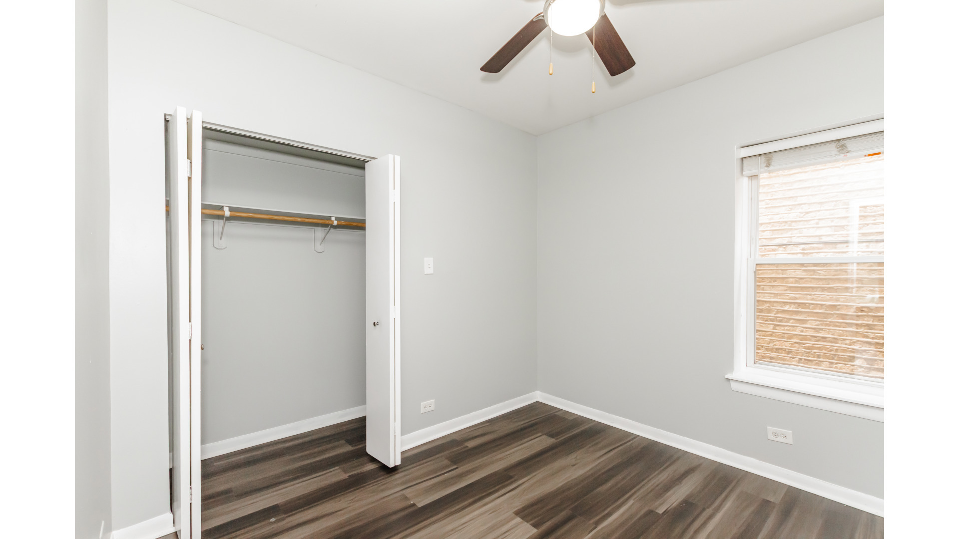 2400 North Kilbourn Avenue, Unit 2 Chicago, IL 60639 - Photo 9 of 10 a view of an empty room with wooden floor and a window