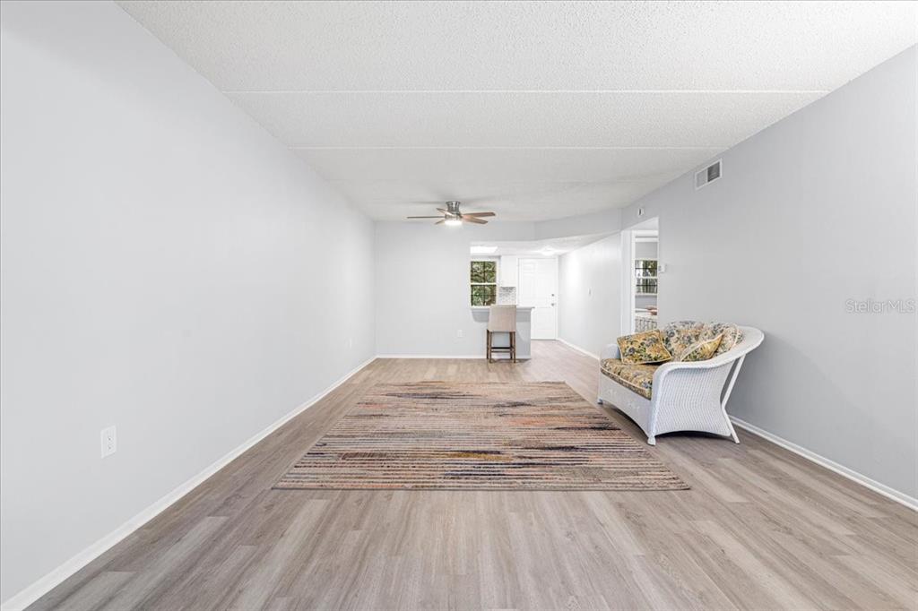821 Patricia Avenue, Unit 202 Dunedin, FL 34698 - Photo 13 of 37 a view of wooden floor and chair in a room