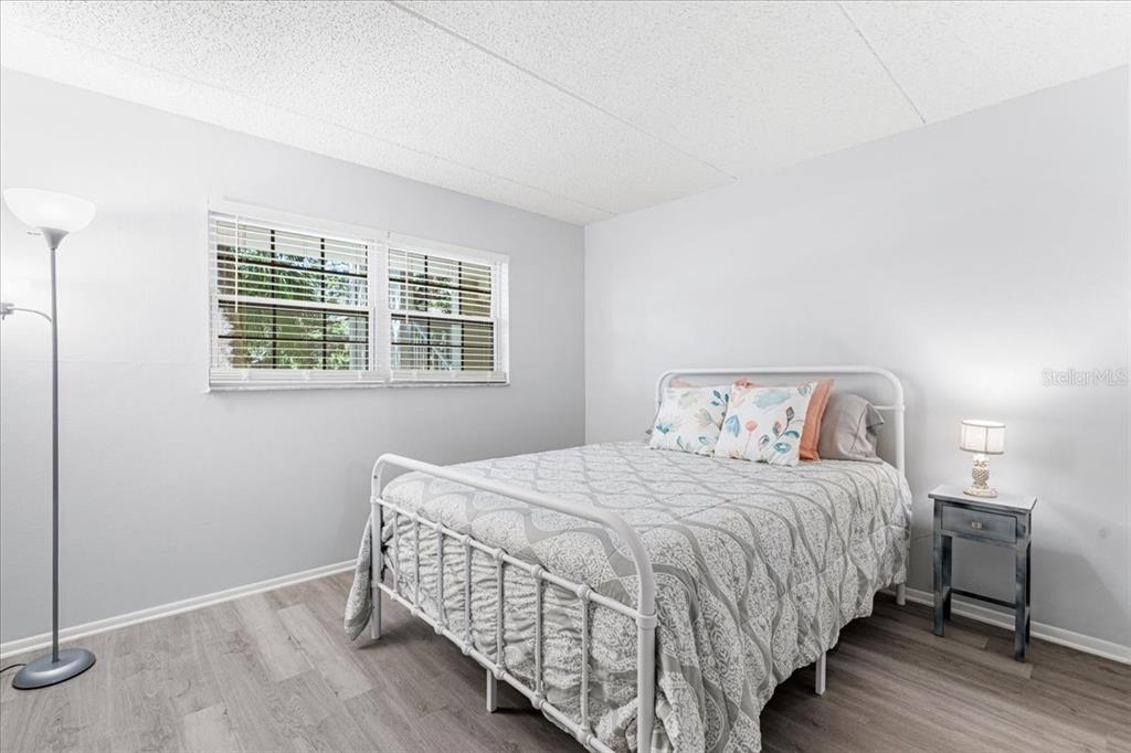 821 Patricia Avenue, Unit 202 Dunedin, FL 34698 - Photo 15 of 37 a bedroom with a bed and a window