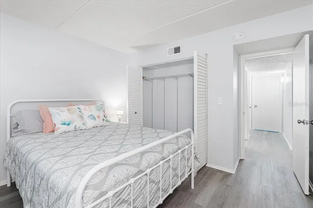 a bedroom with a bed and a mirror