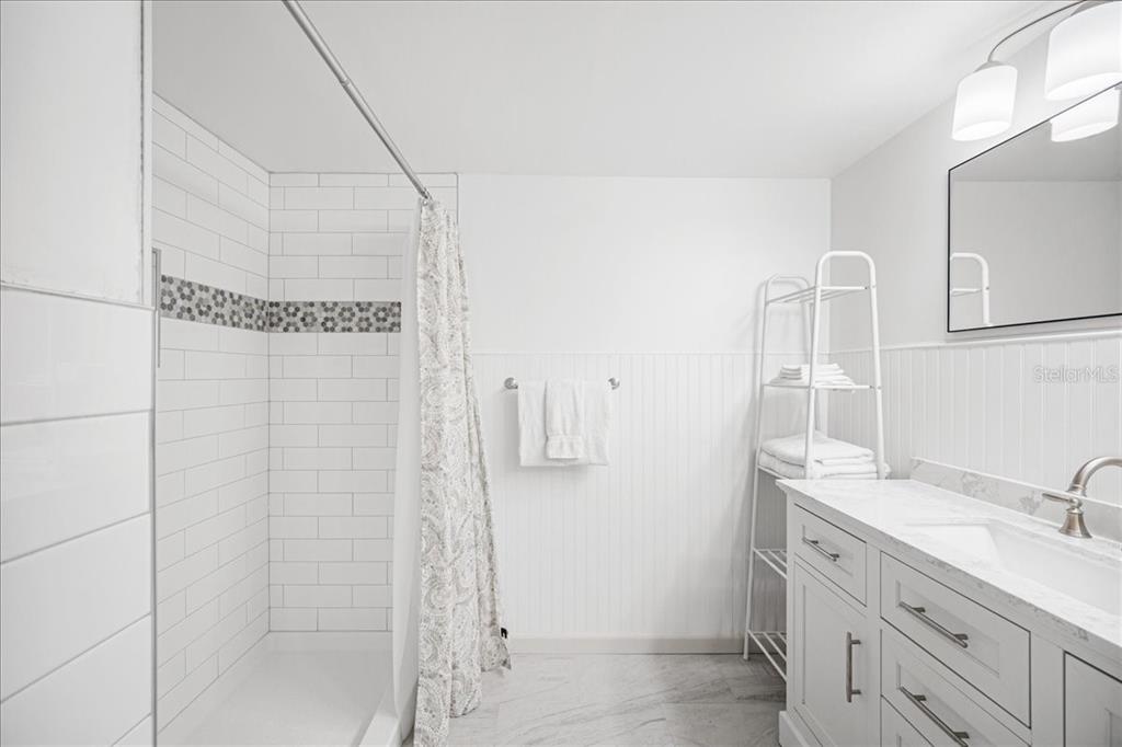 821 Patricia Avenue, Unit 202 Dunedin, FL 34698 - Photo 17 of 37 a bathroom with a sink and a mirror