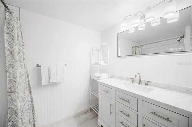 a bathroom with a sink a mirror and vanity