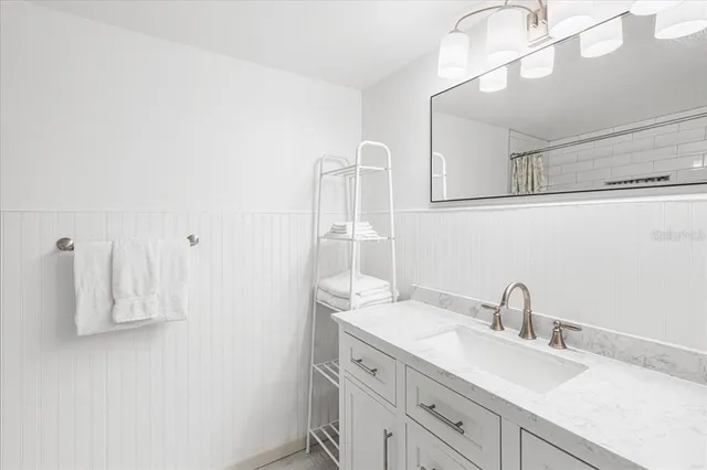 a bathroom with a sink vanity and a mirror