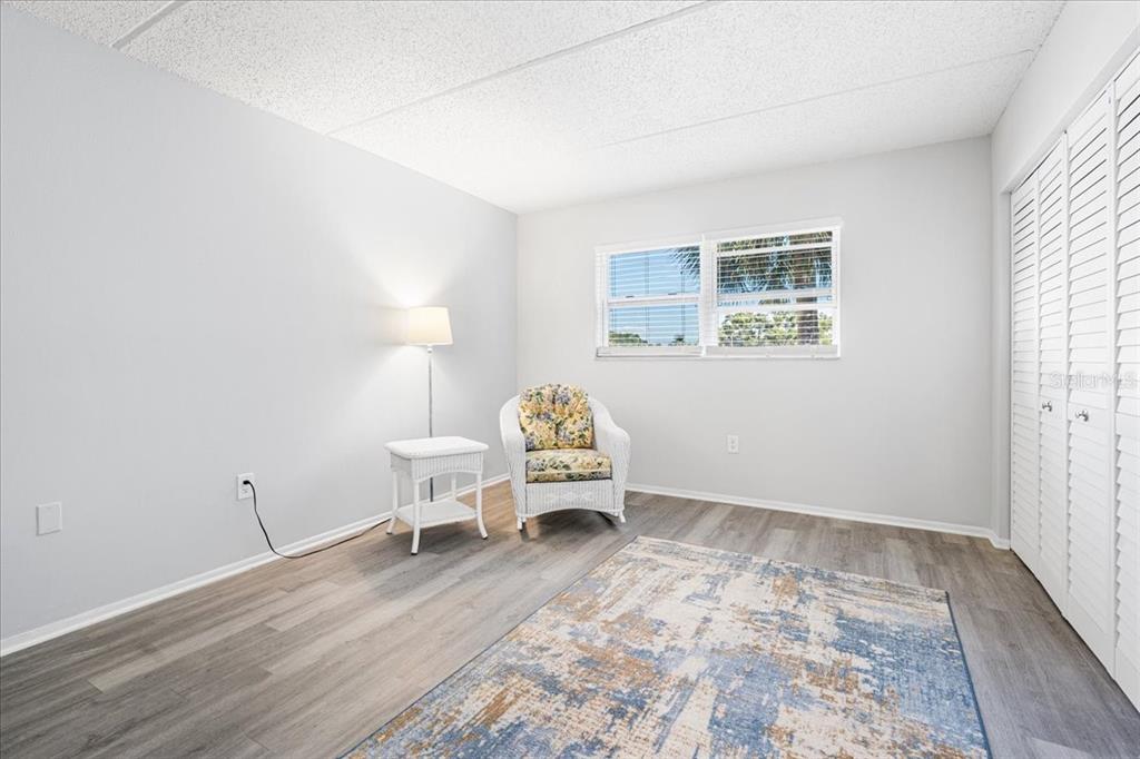 821 Patricia Avenue, Unit 202 Dunedin, FL 34698 - Photo 21 of 37 a bedroom with a bed and a window