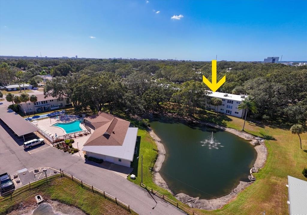 821 Patricia Avenue, Unit 202 Dunedin, FL 34698 - Photo 25 of 37 an aerial view of a house with a swimming pool outdoor seating and yard