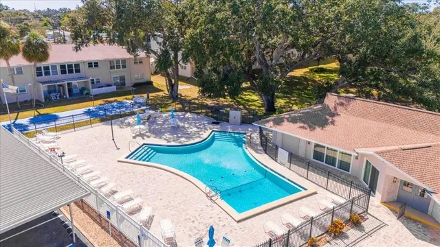 a view of a house with backyard and sitting area