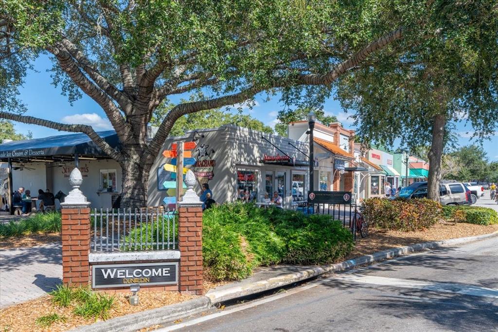 821 Patricia Avenue, Unit 202 Dunedin, FL 34698 - Photo 34 of 37 a sign on the side of a road