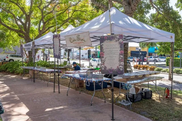 a view of a patio with table and chairs under an umbrella