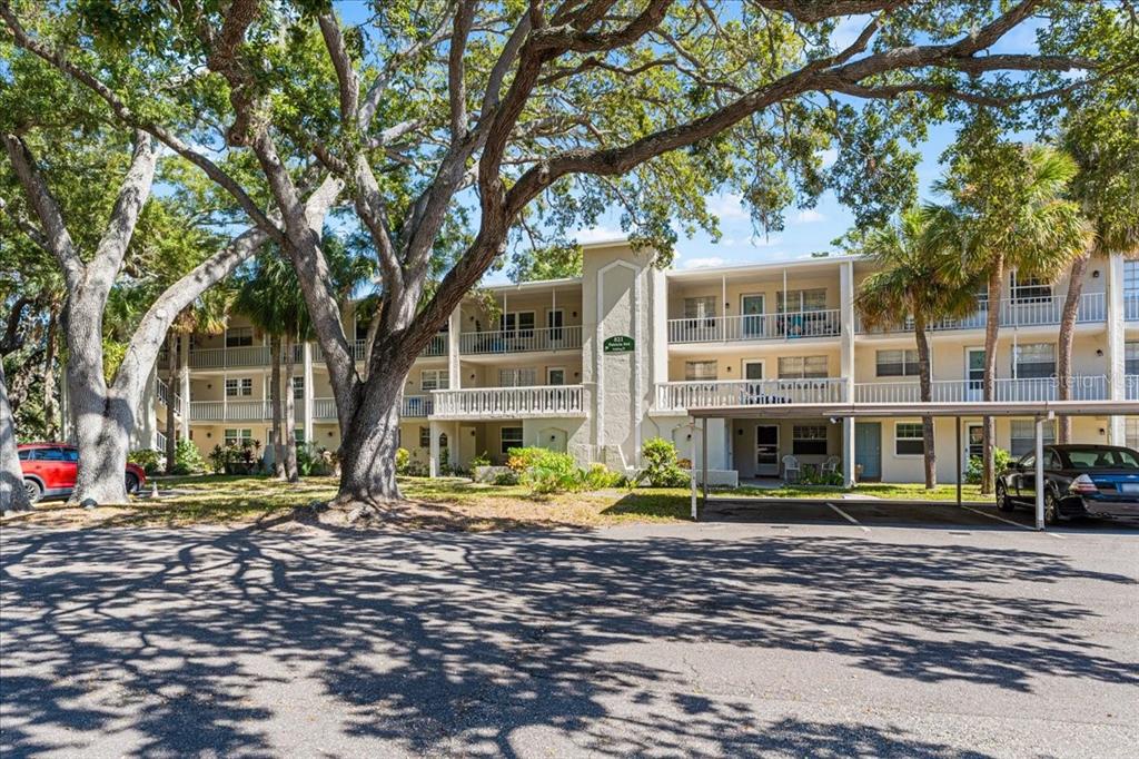 821 Patricia Avenue, Unit 202 Dunedin, FL 34698 - Photo 4 of 37 a front view of a building with street view