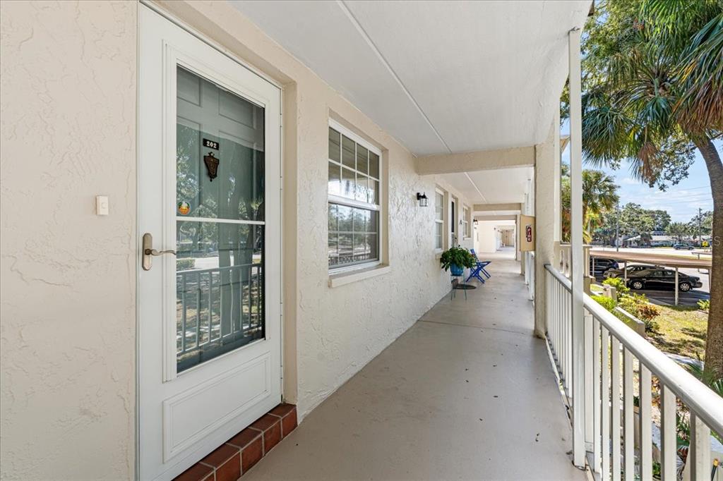 821 Patricia Avenue, Unit 202 Dunedin, FL 34698 - Photo 5 of 37 a view of a hallway with wooden floor and windows