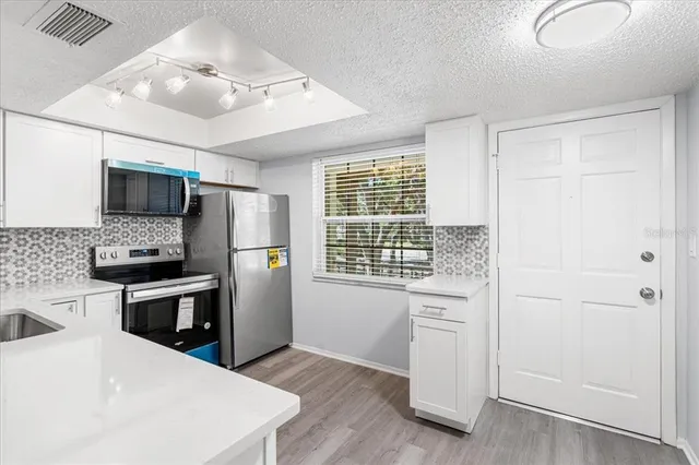 a kitchen with a refrigerator stove and microwave