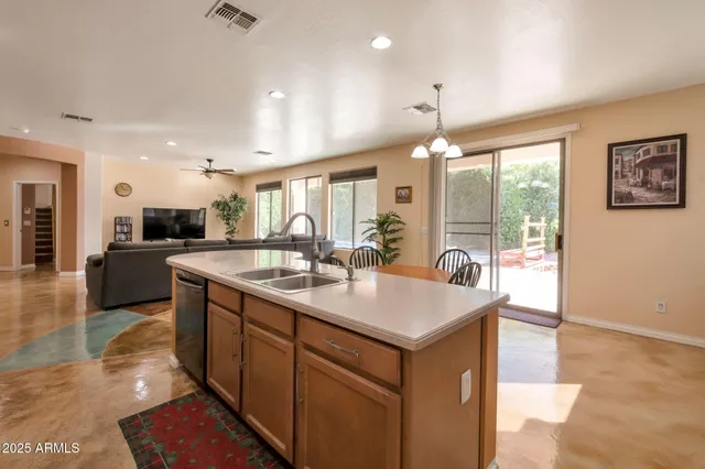 a large kitchen with kitchen island a sink counter space and a dining table