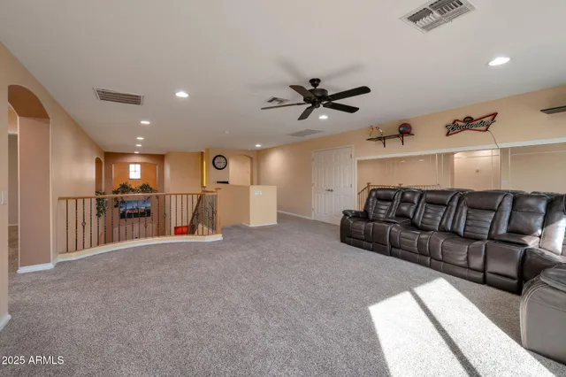 a view of a livingroom with furniture and a ceiling fan