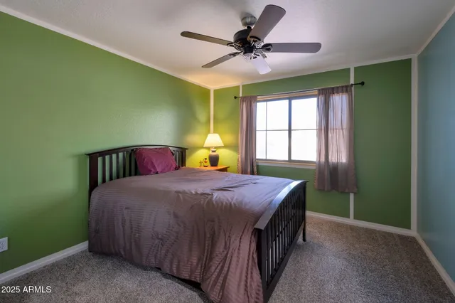 a spacious bedroom with a bed and a chandelier
