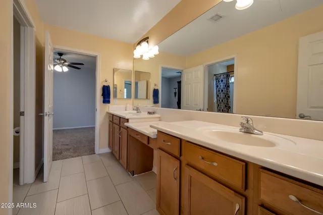 a spacious bathroom with a granite countertop sink mirror and
