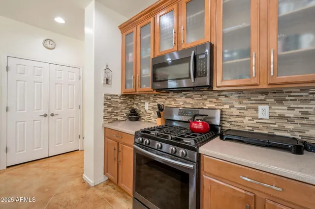 a kitchen with stainless steel appliances granite countertop a stove microwave and sink