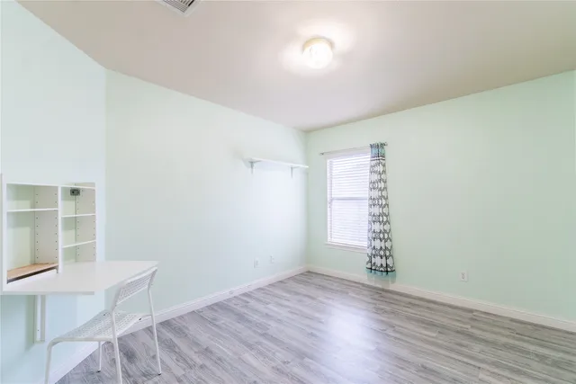 a bathroom with a granite countertop bathtub shower sink vanity and mirror