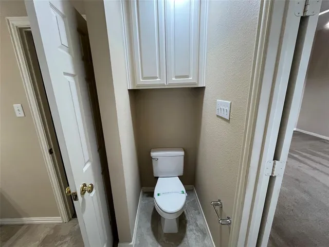 a white toilet sitting next to a sink