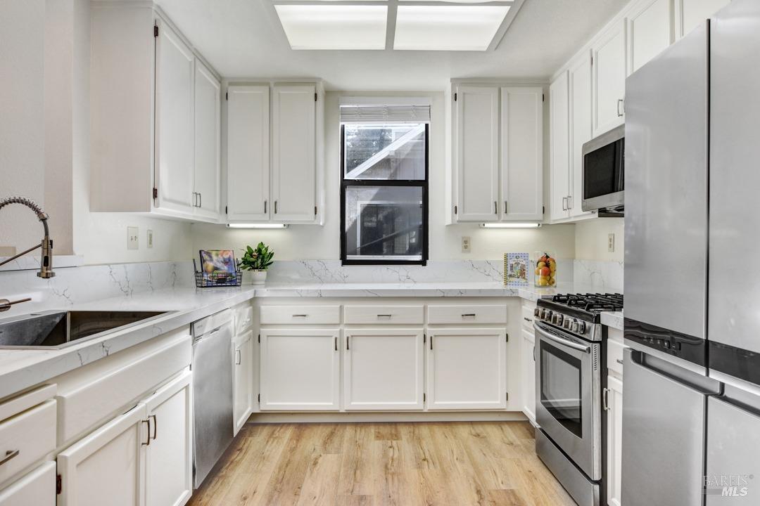 623 Cherry Avenue Sonoma, CA 95476 - Photo 1 of 1 a kitchen with white cabinets and appliances