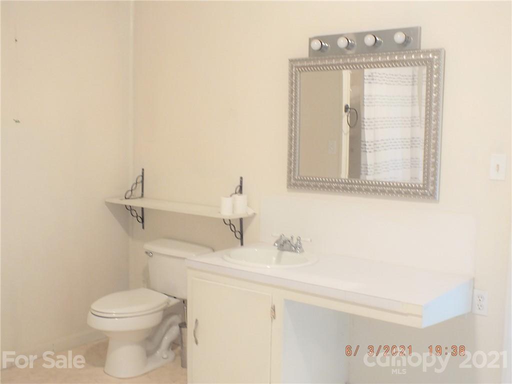 1473 Old Landsford Road Lancaster, SC 29720 - Photo 15 of 29 a bathroom with a sink a toilet and mirror