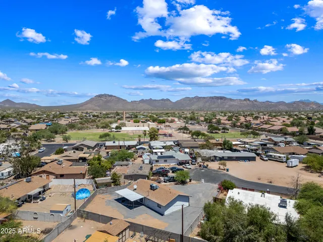 a view of a city with lots of residential buildings ocean and mountain view in back