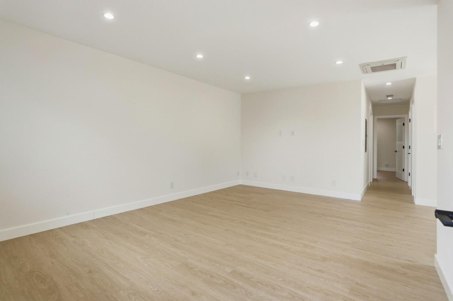 474 Oliver Street Milpitas, CA 95035 - Photo 4 of 27 an empty room with wooden floor and a ceiling fan