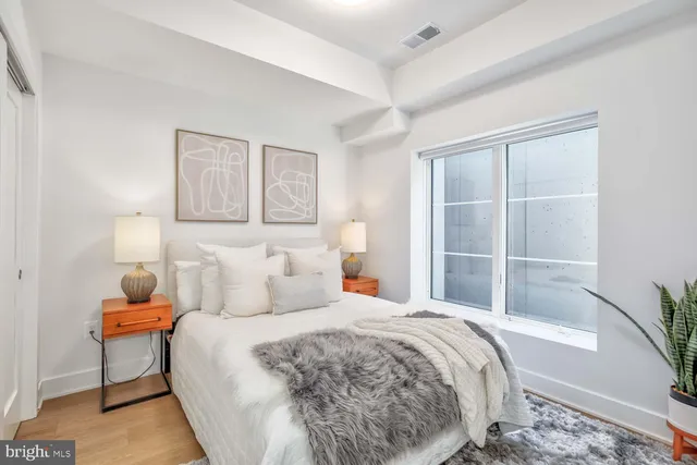 a bedroom with a bed and a window