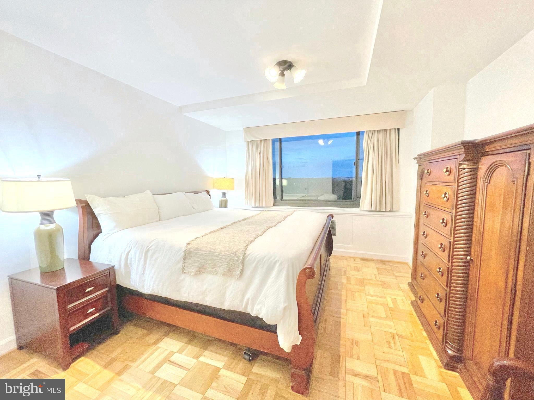 1011 Arlington Boulevard, Unit 930 Arlington, VA 22209 - Photo 11 of 42 a spacious bedroom with a bed and wooden floor