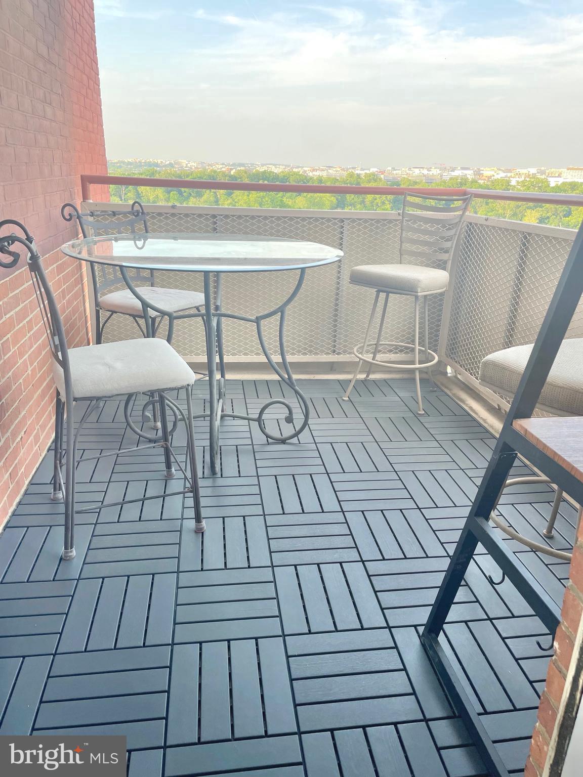1011 Arlington Boulevard, Unit 930 Arlington, VA 22209 - Photo 16 of 42 a view of roof deck with dining table and chair with wooden floor