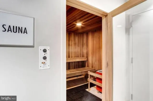 a city street with tall buildings and a yard