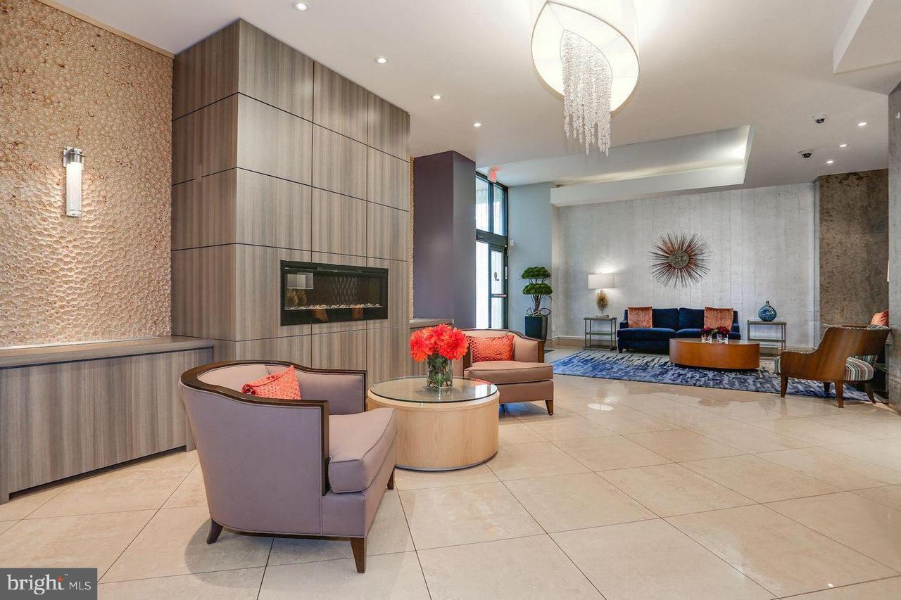 1011 Arlington Boulevard, Unit 930 Arlington, VA 22209 - Photo 28 of 42 a living room with furniture a flat screen tv and a fireplace