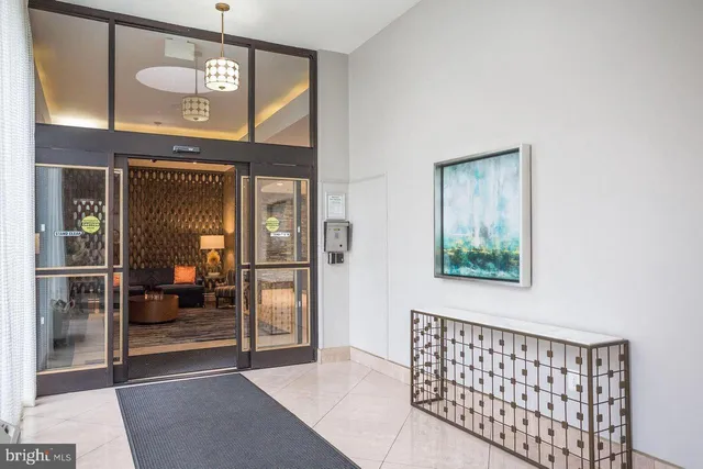 a street view with tall buildings and a bench