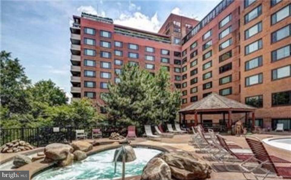 1011 Arlington Boulevard, Unit 930 Arlington, VA 22209 - Photo 32 of 42 a street view with tall buildings and a bench