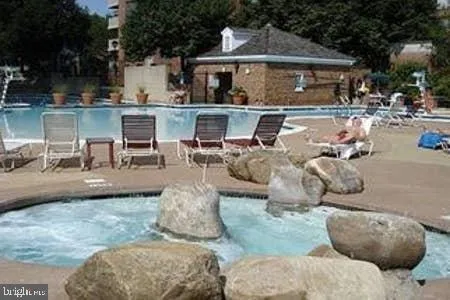 a view of a house with pool and garden