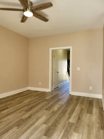 a view of an empty room with wooden floor