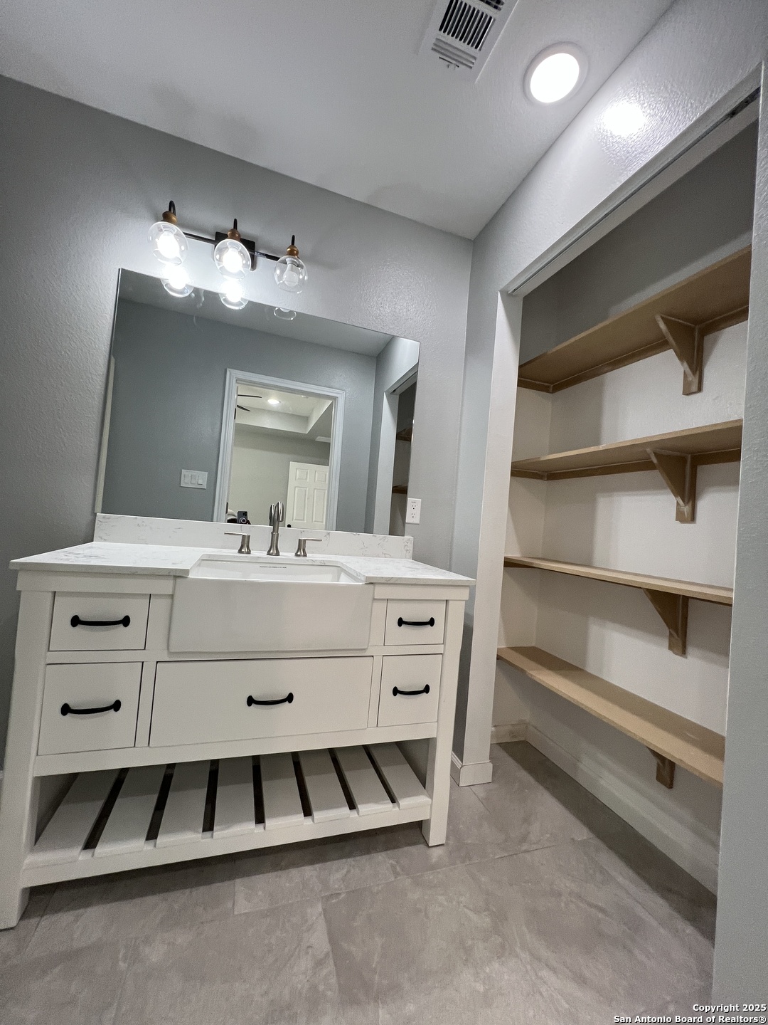 1197 Chisolm Trail Spring Branch, TX 78070 - Photo 6 of 10 a bathroom with a sink double vanity and a mirror